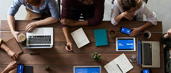 People sitting around a desk doing work